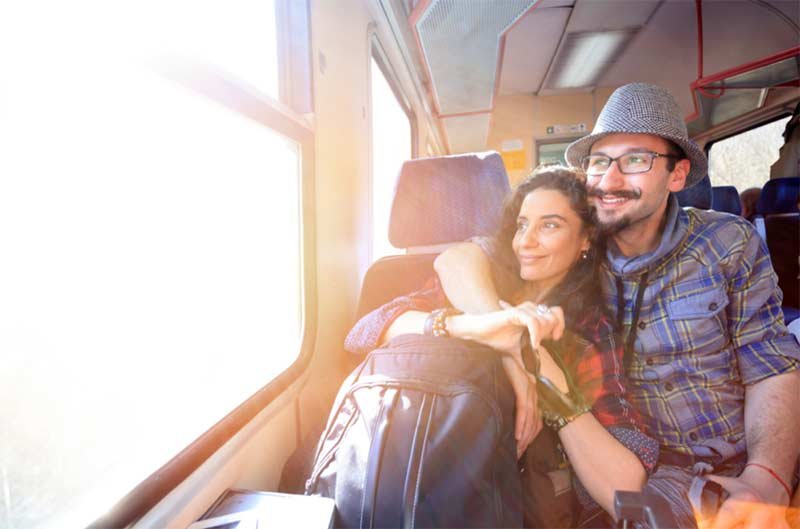 Couple looking trough the window while traveling in train
